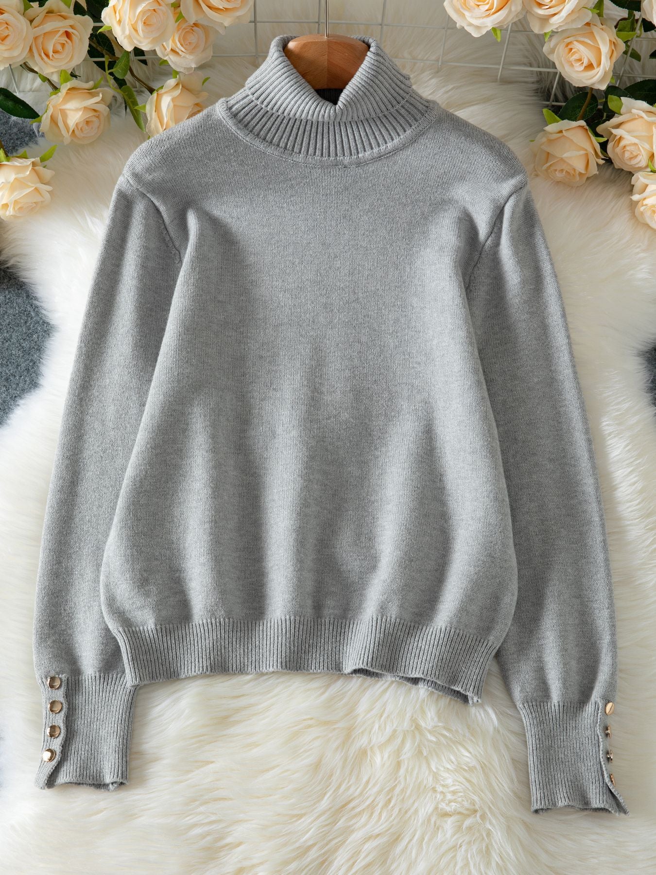 Grey women's knit lapel pullover top featuring button details on the sleeves for a stylish look