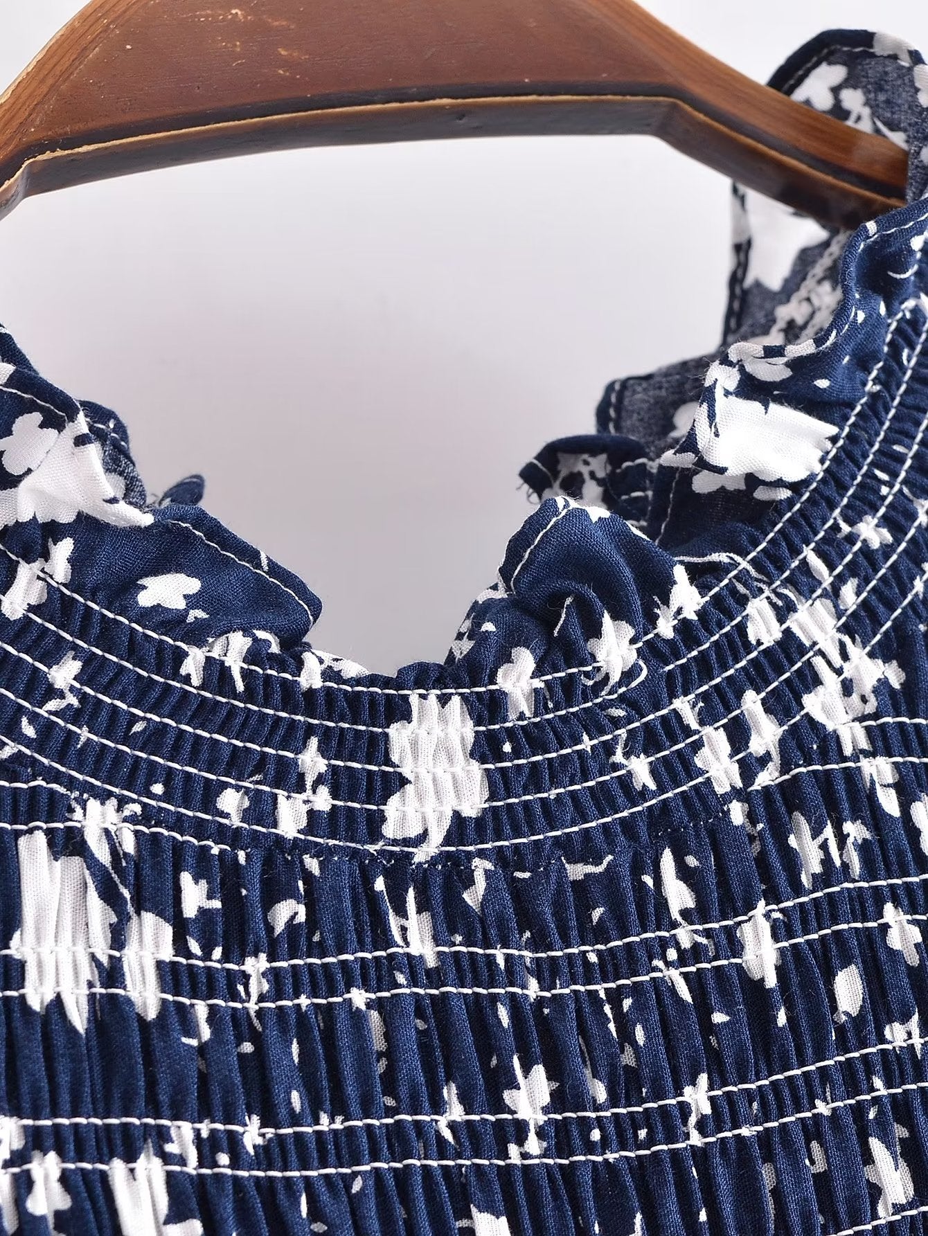 Close-up of Malbusaat women's summer floral dress with blue and white floral pattern and ruched detailing