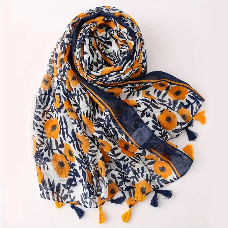 Trendy ladies fashion scarves featuring vibrant yellow and navy floral print with tassels for all seasons