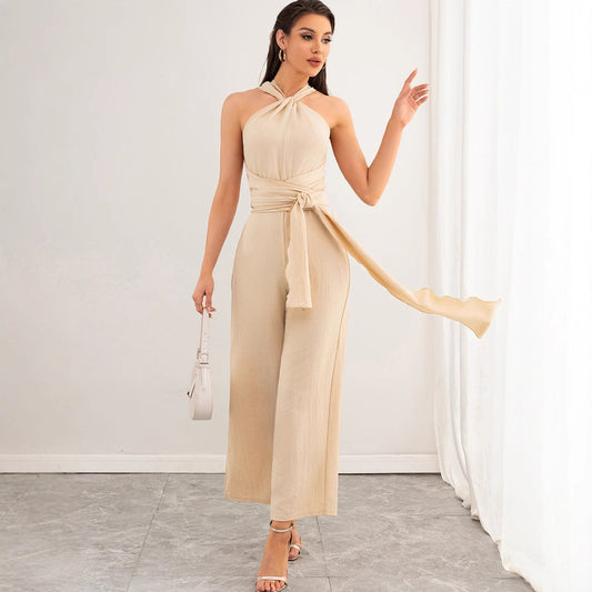 Malbusaat beige halter backless women's jumpsuit with waist tie wide cropped legs and strappy heels