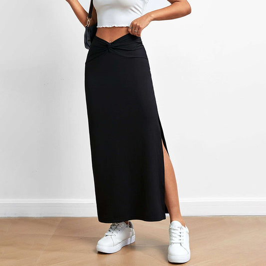 Black drape slit skirt by Malbusaat styled with white sneakers and cropped white top