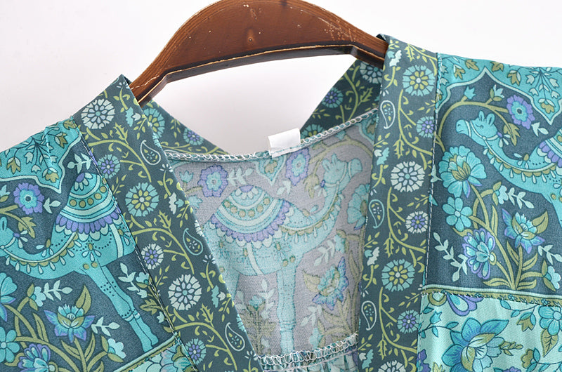 Close-up of Malbusaat bohemian summer maxi dress with blue floral and camel print fabric