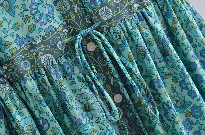 Close-up of Malbusaat bohemian summer maxi dress with blue floral pattern and tie detail
