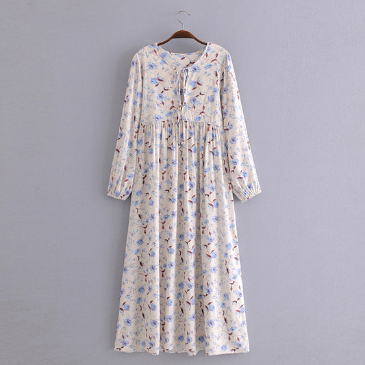 Elegant floral maxi dress in cream with blue and brown flower print and long sleeves by Malbusaat