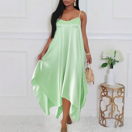Elegant long sling dress for women in light green satin fabric styled with minimal accessories