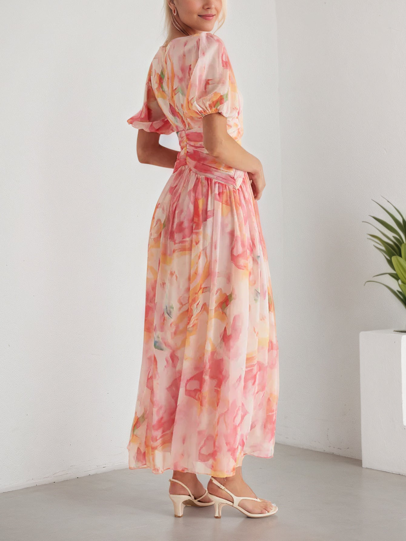 Model wearing a floral chiffon maxi dress with a flowing design and pastel colours for a stylish summer look