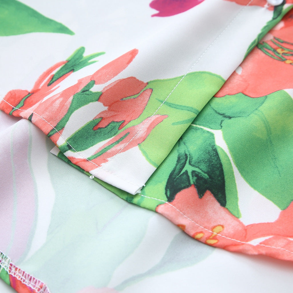 Close-up of a vibrant floral print collared shirt featuring colourful flowers and lush greenery
