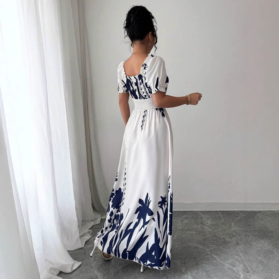Back view of a woman wearing a Floral Square Neck Maxi Dress with Puff Sleeves in white and navy blue