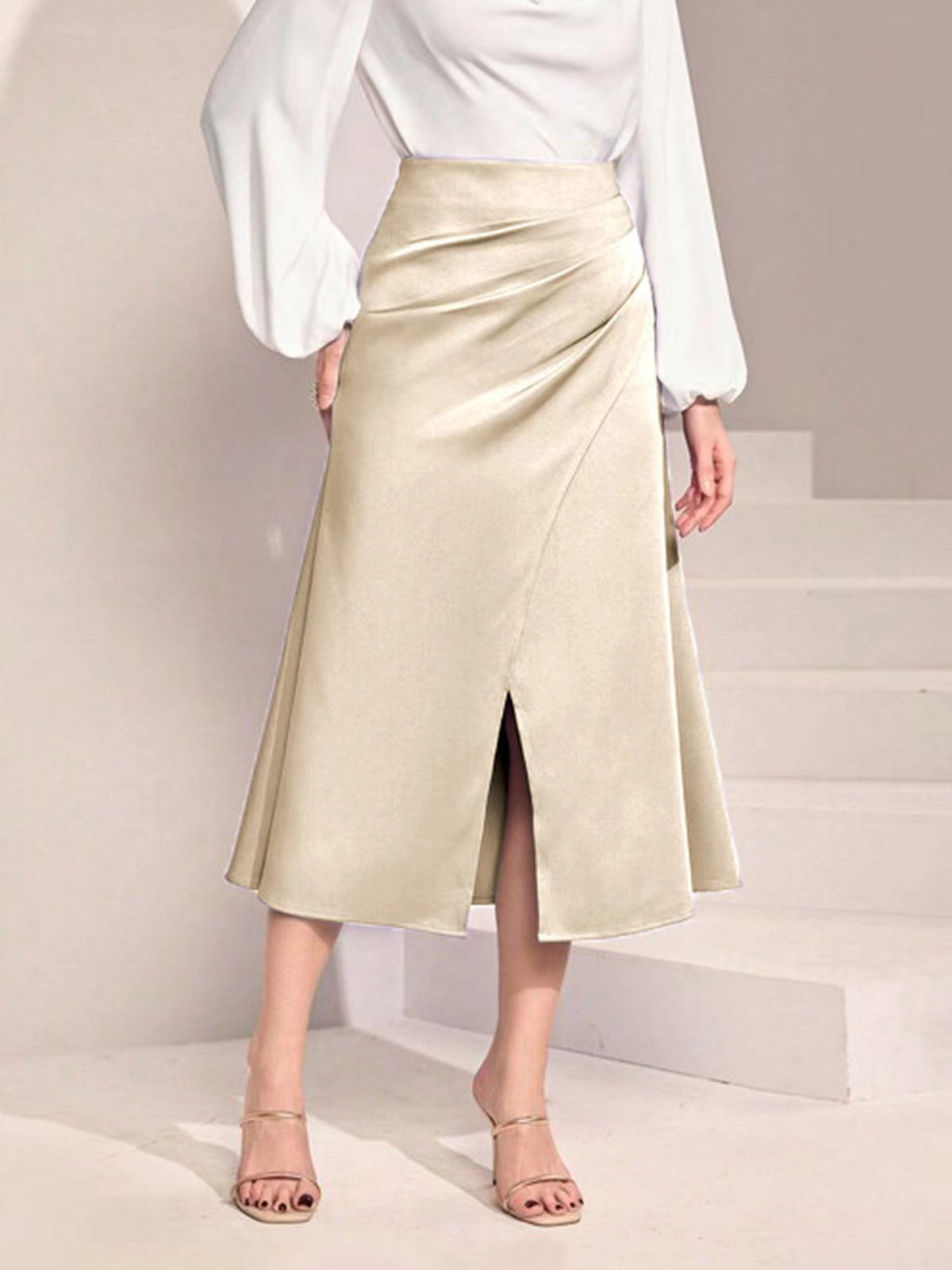 Elegant beige high waist satin skirt with front slit styled with white blouse and nude heels