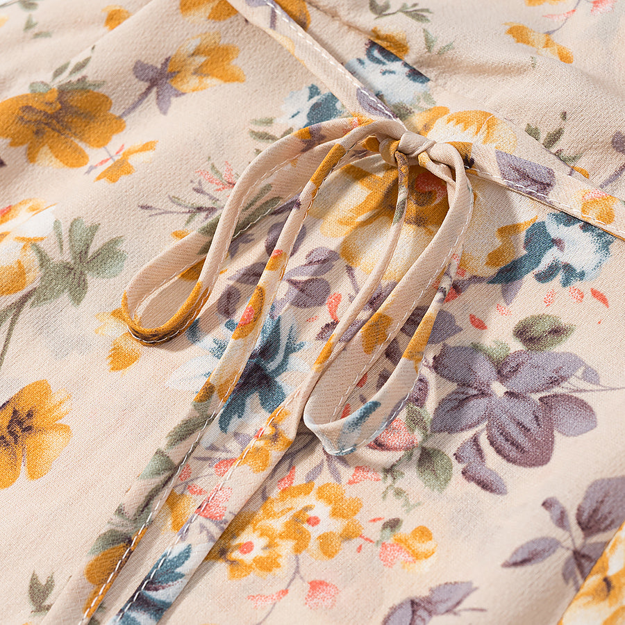 Close-up of lace up floral pullover dress showing vibrant floral patterns and tie detail