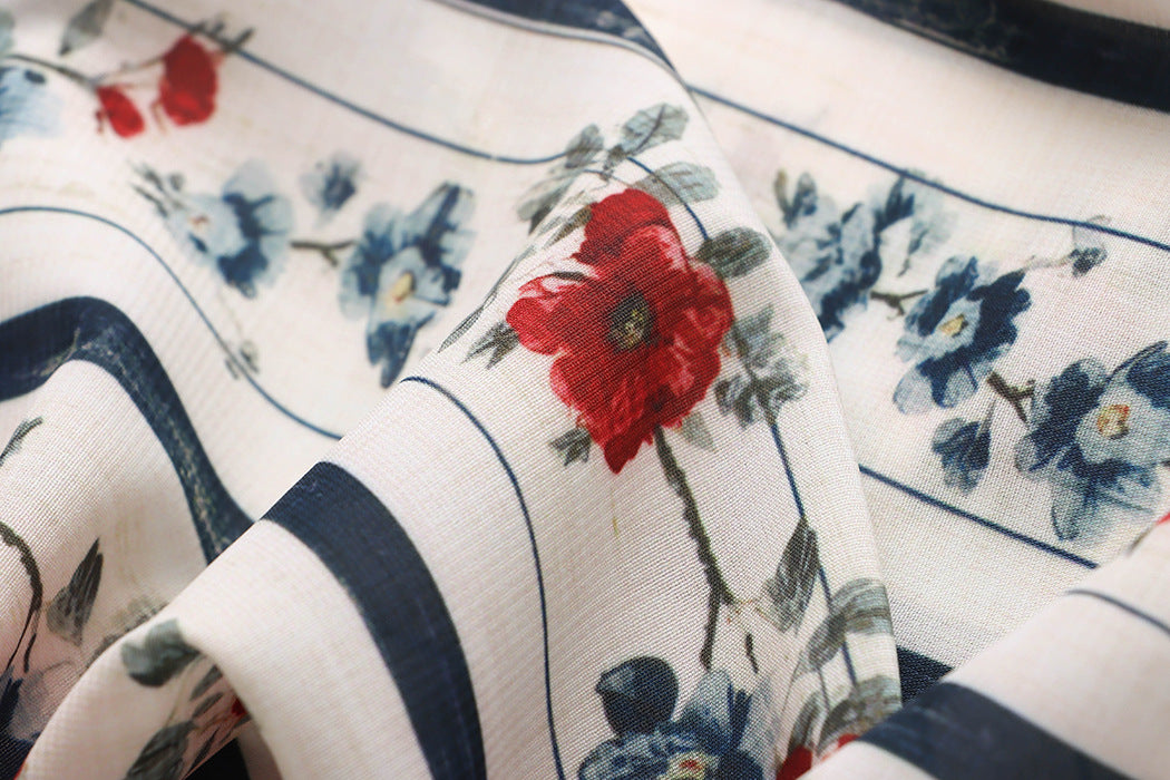 Malbusaat floral fabric close up featuring cream base navy stripes and red blue flowers loose straight wide pants for women