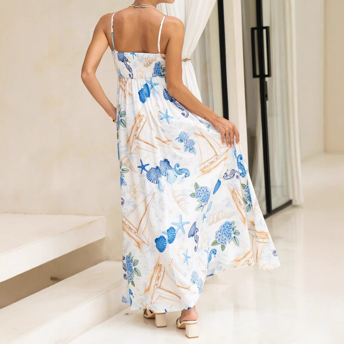 Malbusaat nautical print maxi dress with a flowy design and tropical marine patterns in blue and white