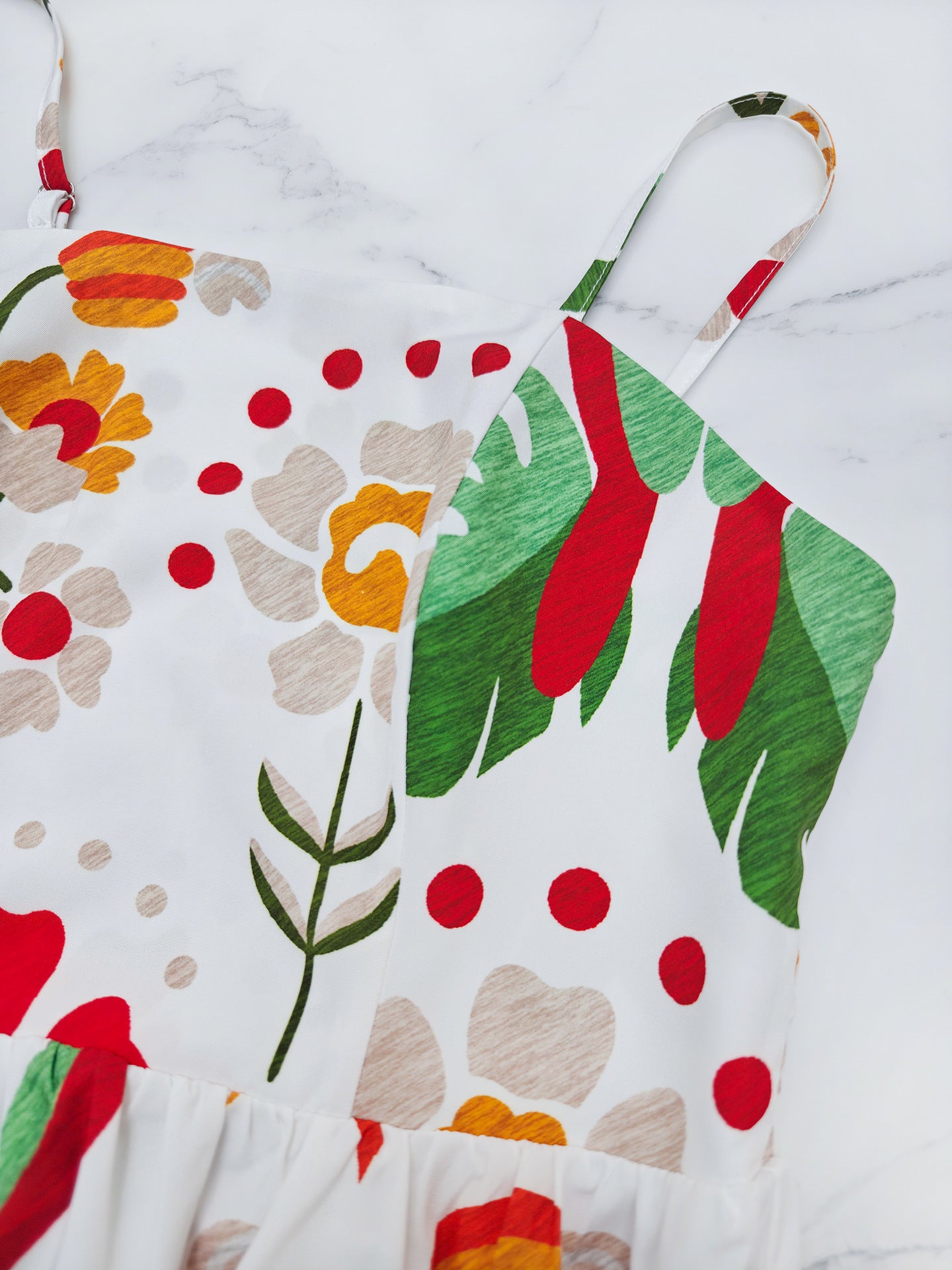 Malbusaat printed strap tiered dress featuring a vibrant floral design on lightweight fabric