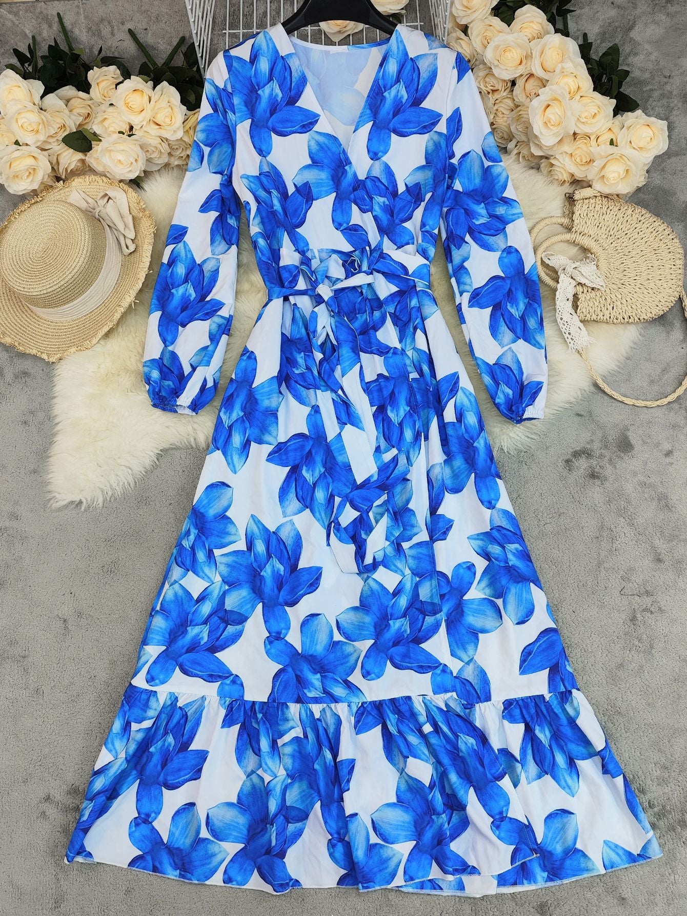 Malbusaat printed v neck tiered dress featuring a blue floral pattern on a light background
