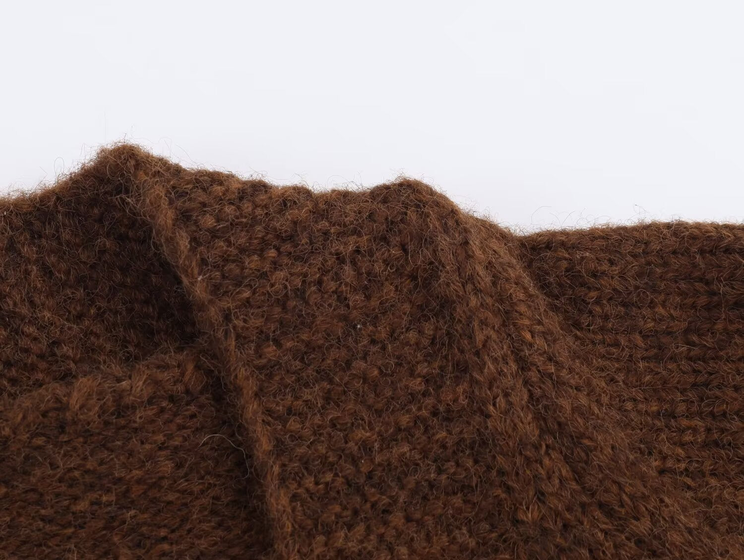 Close-up view of a brown retro v neck knit cardigan showcasing its textured fabric