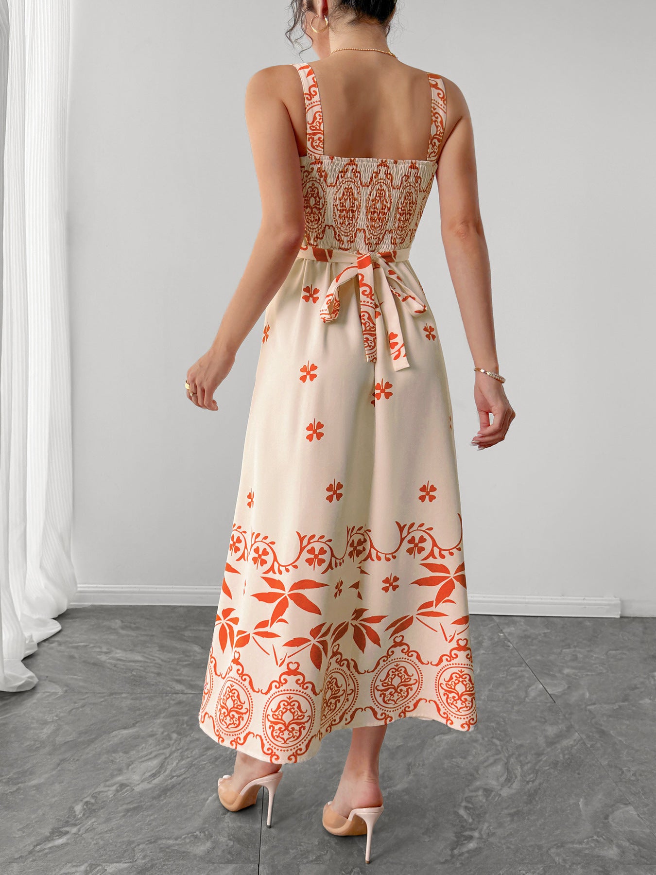 Back view of PLAYA retro waist maxi dress in cream with floral prints and a tie detail