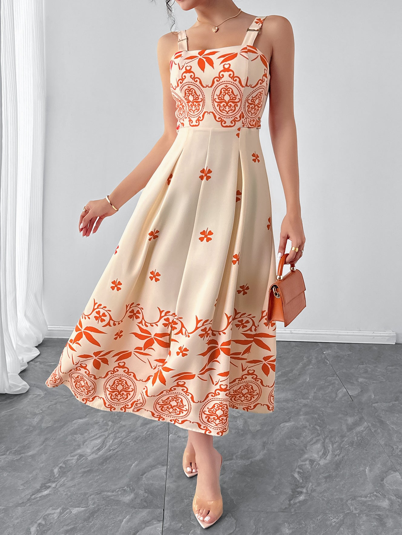 Cream and orange patterned retro waist maxi dress with a flattering fit and elegant design