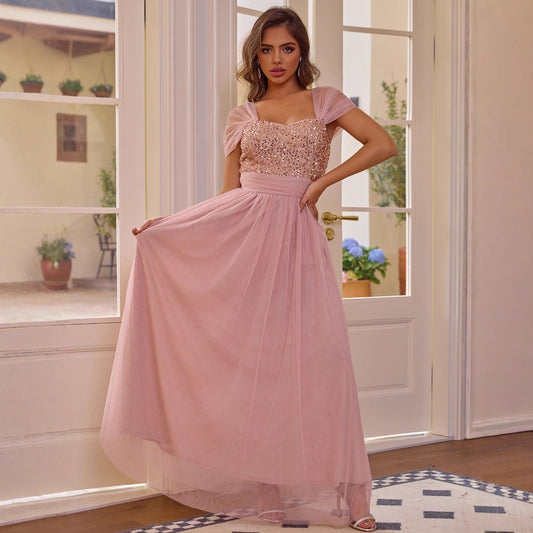Elegant pink sequined short sleeved dress with flowing tulle skirt by Malbusaat
