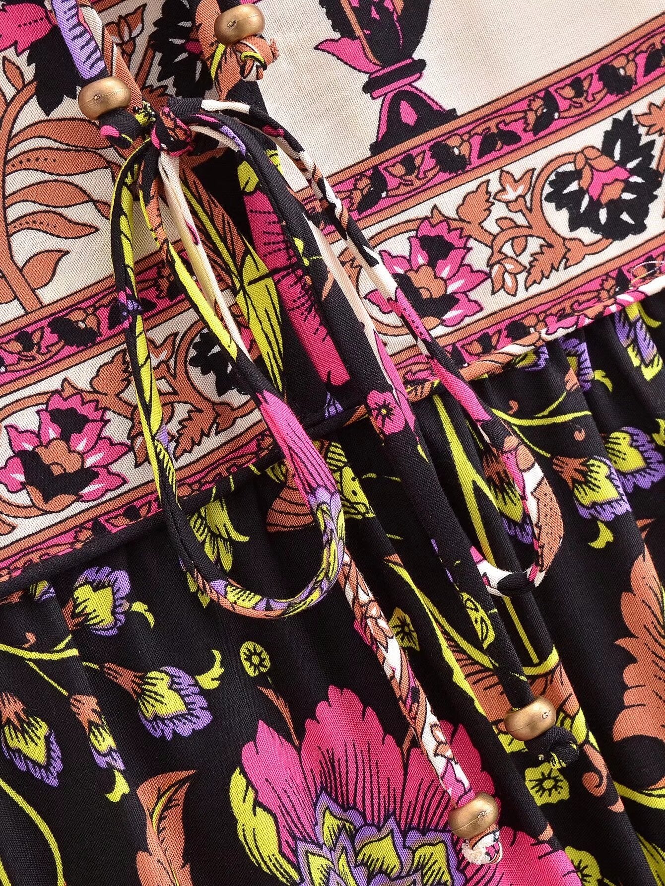 Close-up of Malbusaat spring floral print maxi dress with vibrant pink and yellow flowers and decorative beads