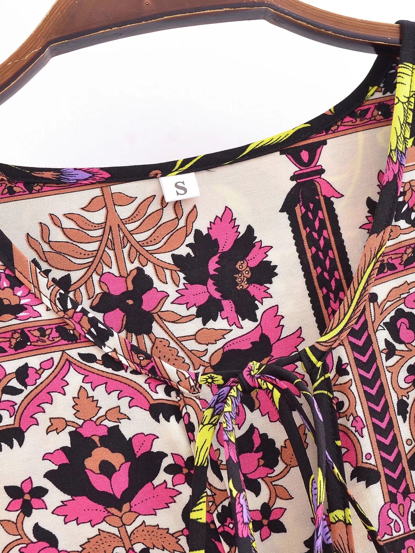 Close-up of Malbusaat spring floral print maxi dress featuring pink and brown floral patterns with drawstring detail