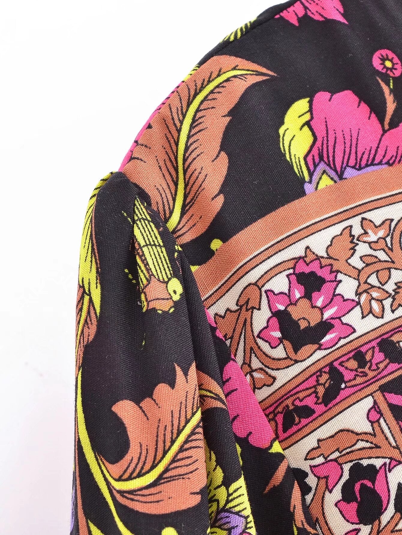 Close-up of Malbusaat spring floral print maxi dress showing colourful detailed floral patterns on black fabric