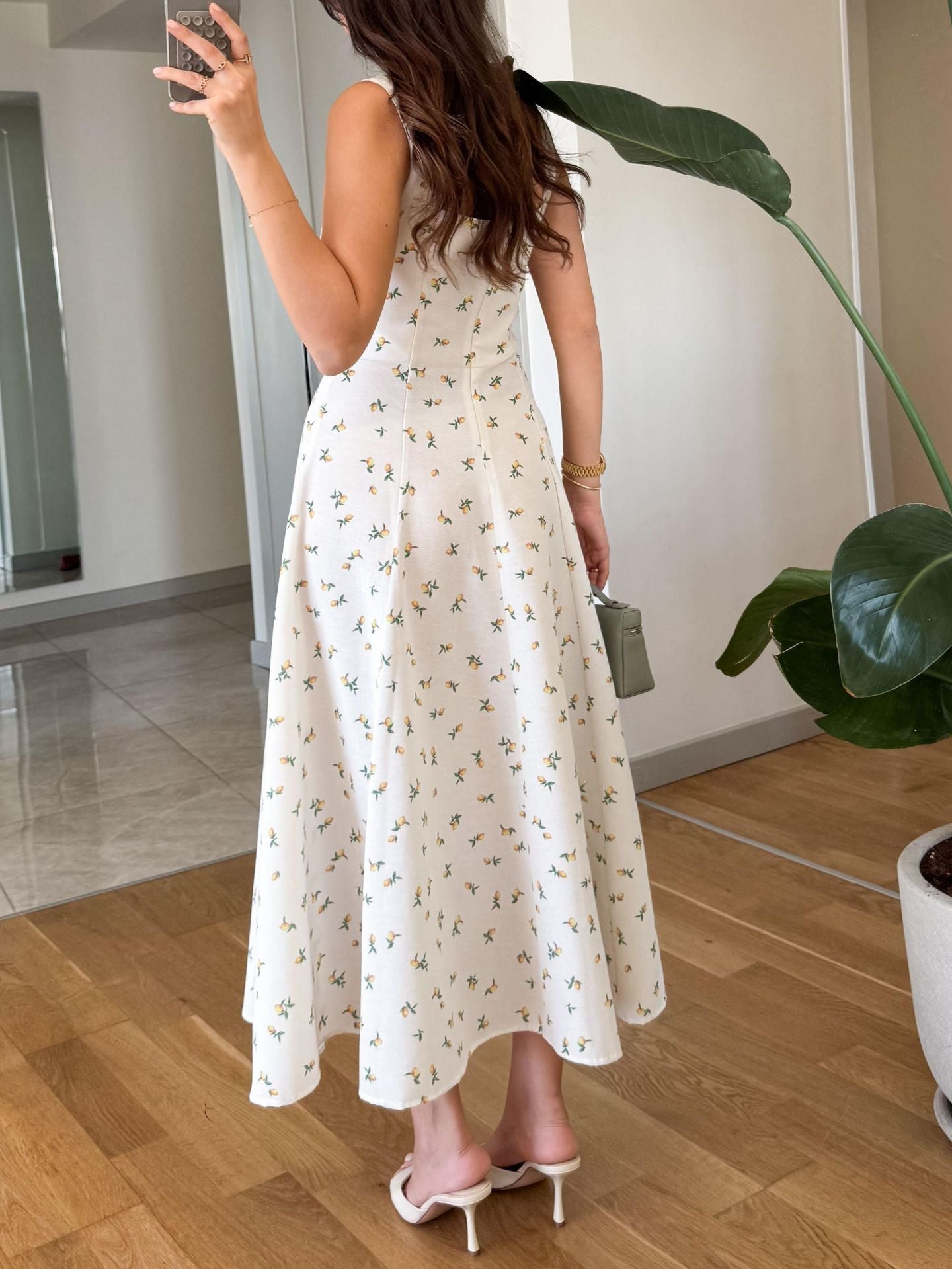 Back view of a woman wearing a square neck holiday midi dress with floral pattern and flowy design