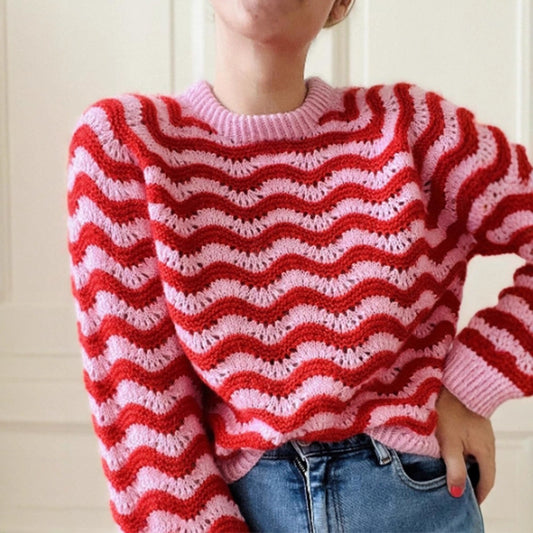 Malbusaat striped knit sweater for women in pink and red wavy pattern paired with blue jeans