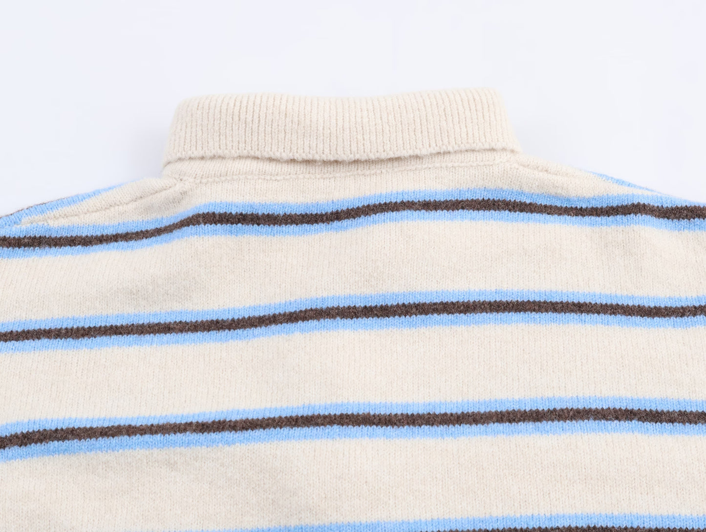 Back view of a Malbusaat striped polo knit pullover for women in beige with blue and brown stripes