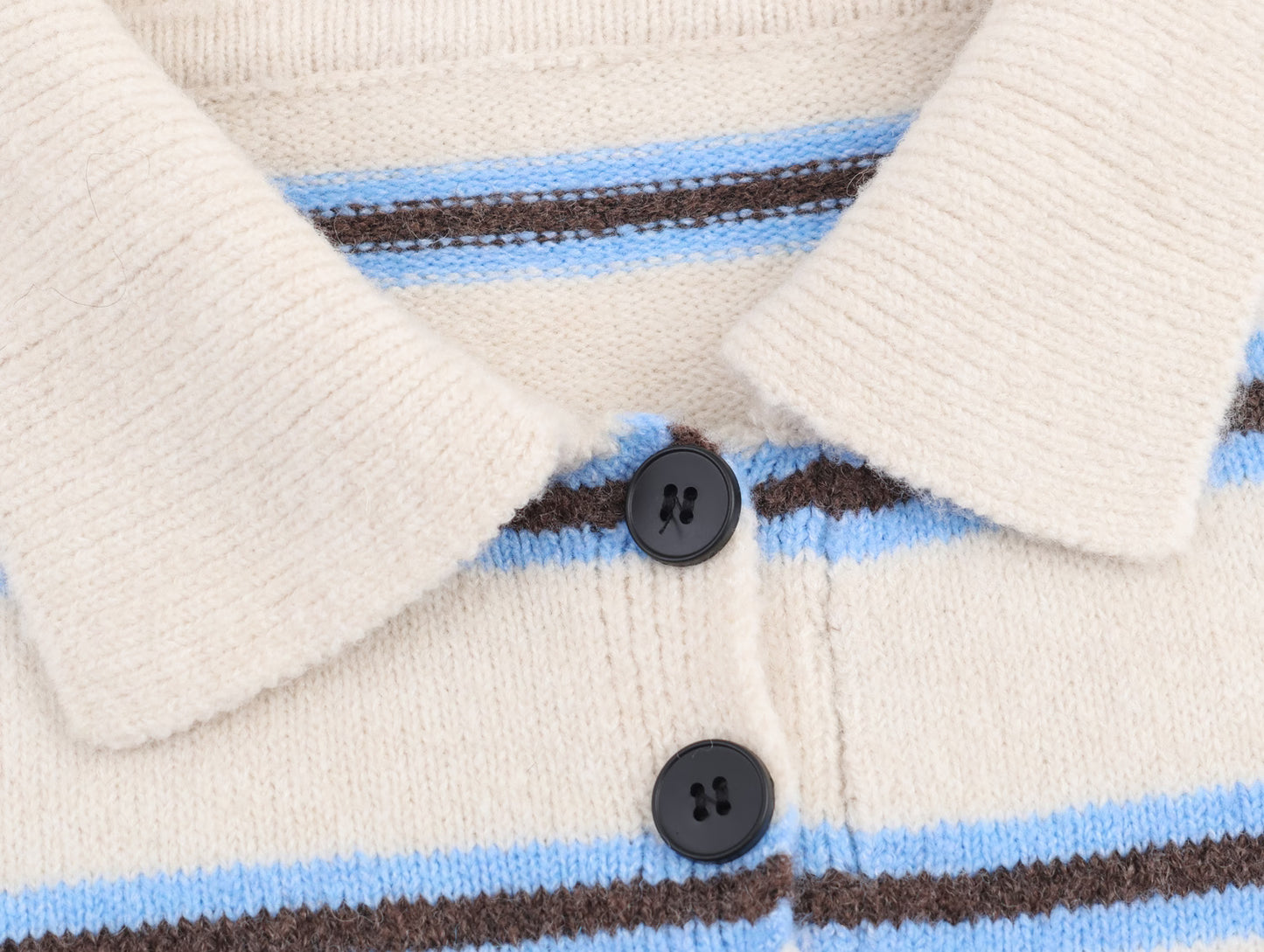 Close-up of Malbusaat striped polo knit pullover for women with blue and brown stripes