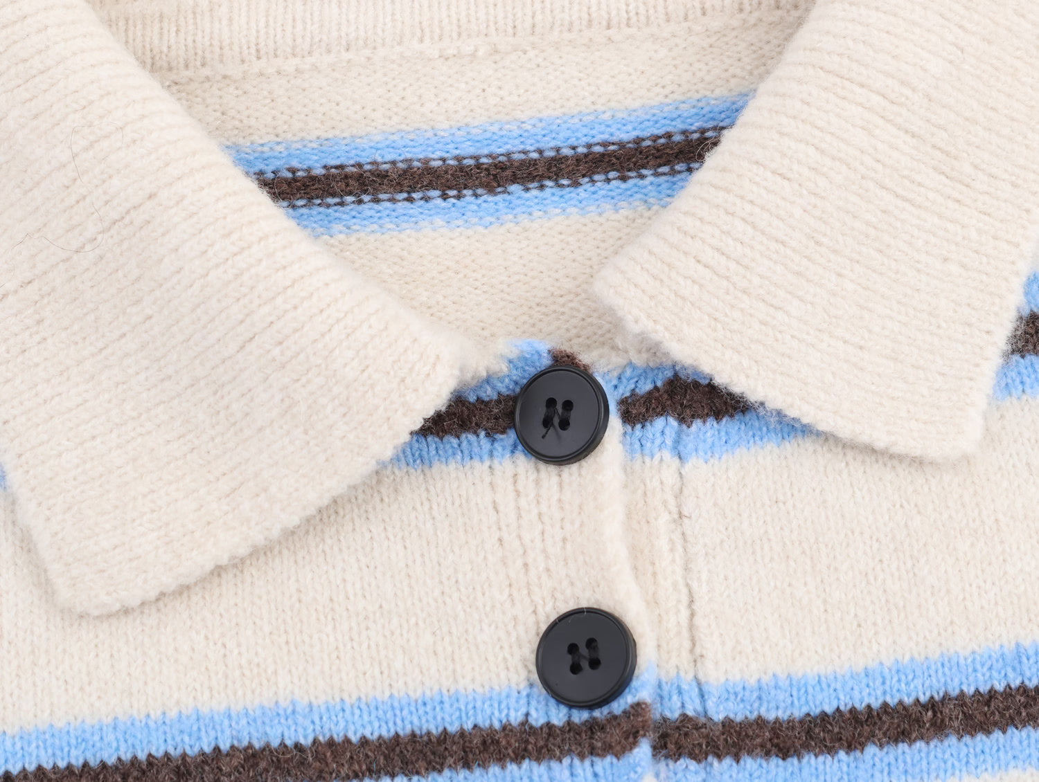 Close-up of Malbusaat striped polo knit pullover for women with blue and brown stripes