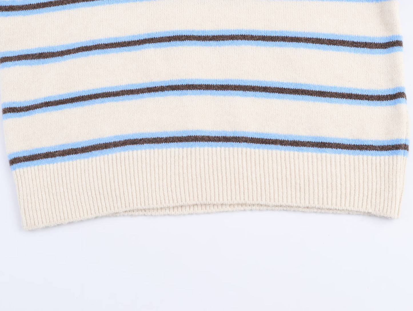 Cream striped polo knit pullover for women with blue and brown stripes at the hem