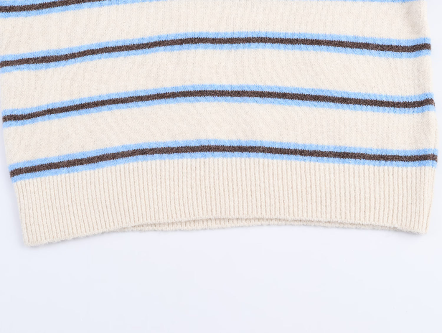 Cream striped polo knit pullover for women with blue and brown stripes at the hem