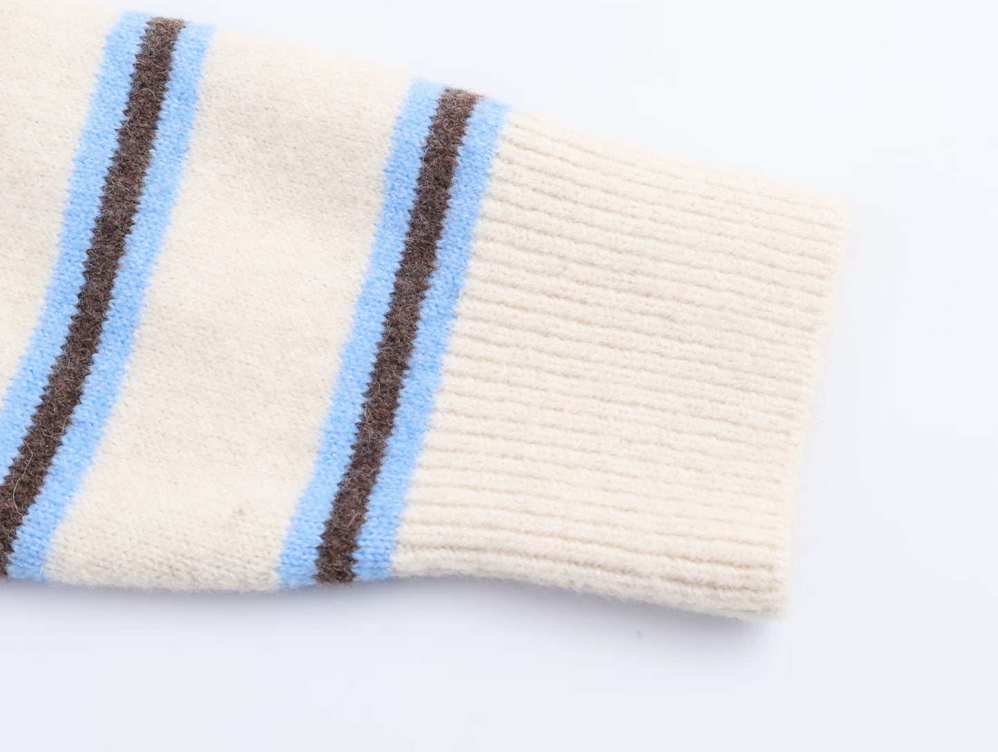 Close-up of striped polo knit pullover for women featuring soft fabric and colourful stripes
