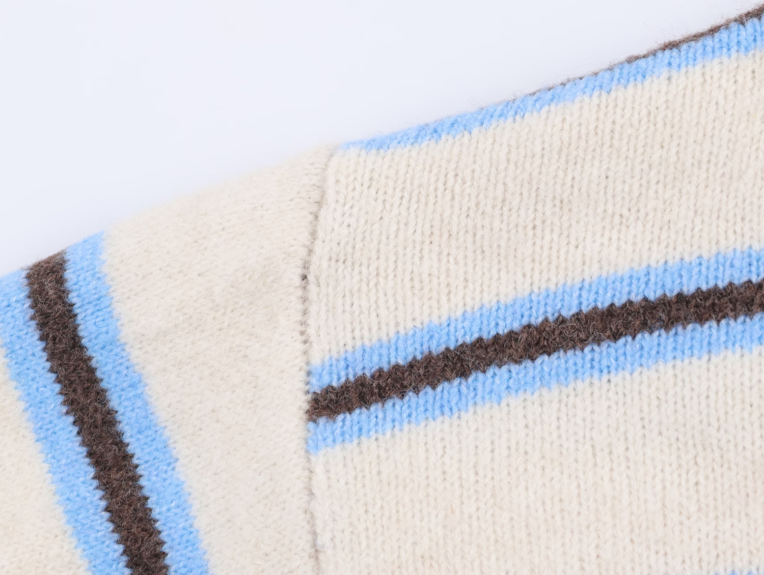 Close-up of a striped polo knit pullover for women showcasing blue and brown stripes