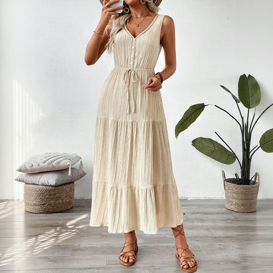 Malbusaat summer V-neck maxi dress in cream with sleeveless design and tiered skirt, styled with sandals