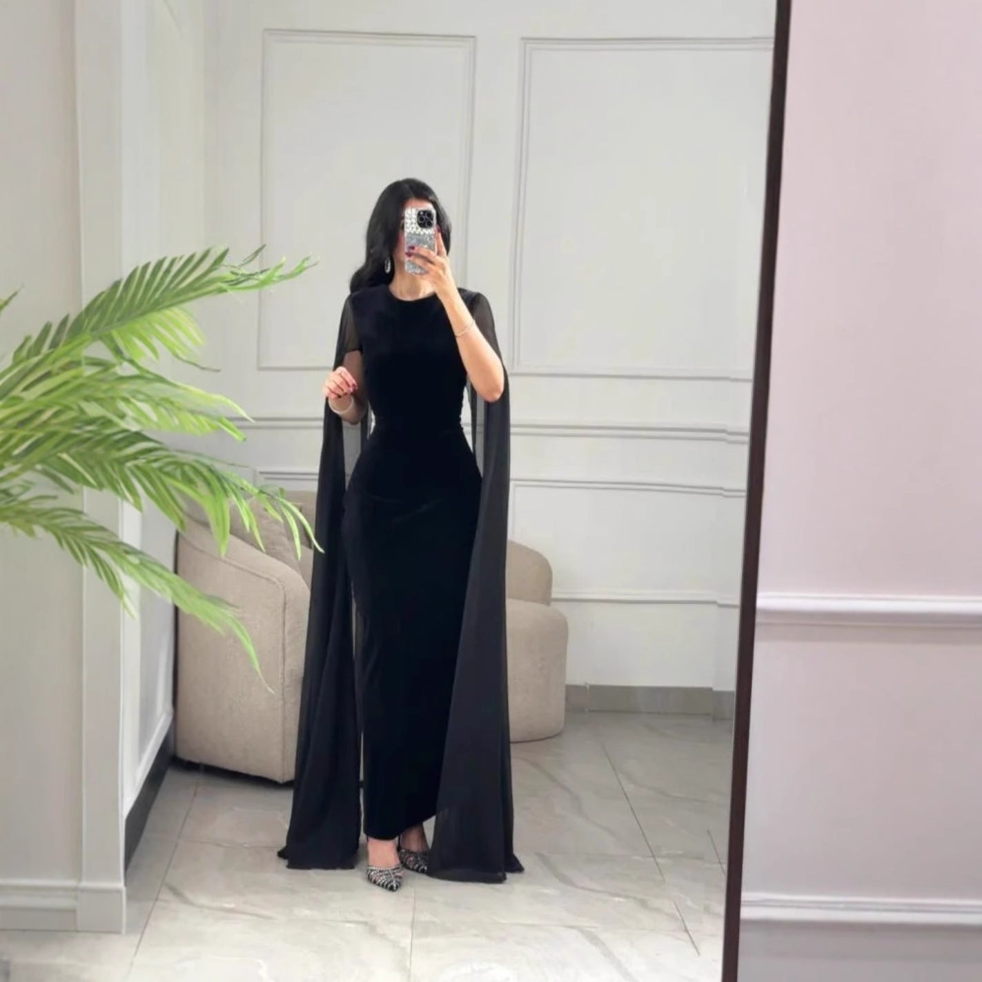 Elegant black velvet sheath maxi dress UK with flowing sleeves for a stylish evening look