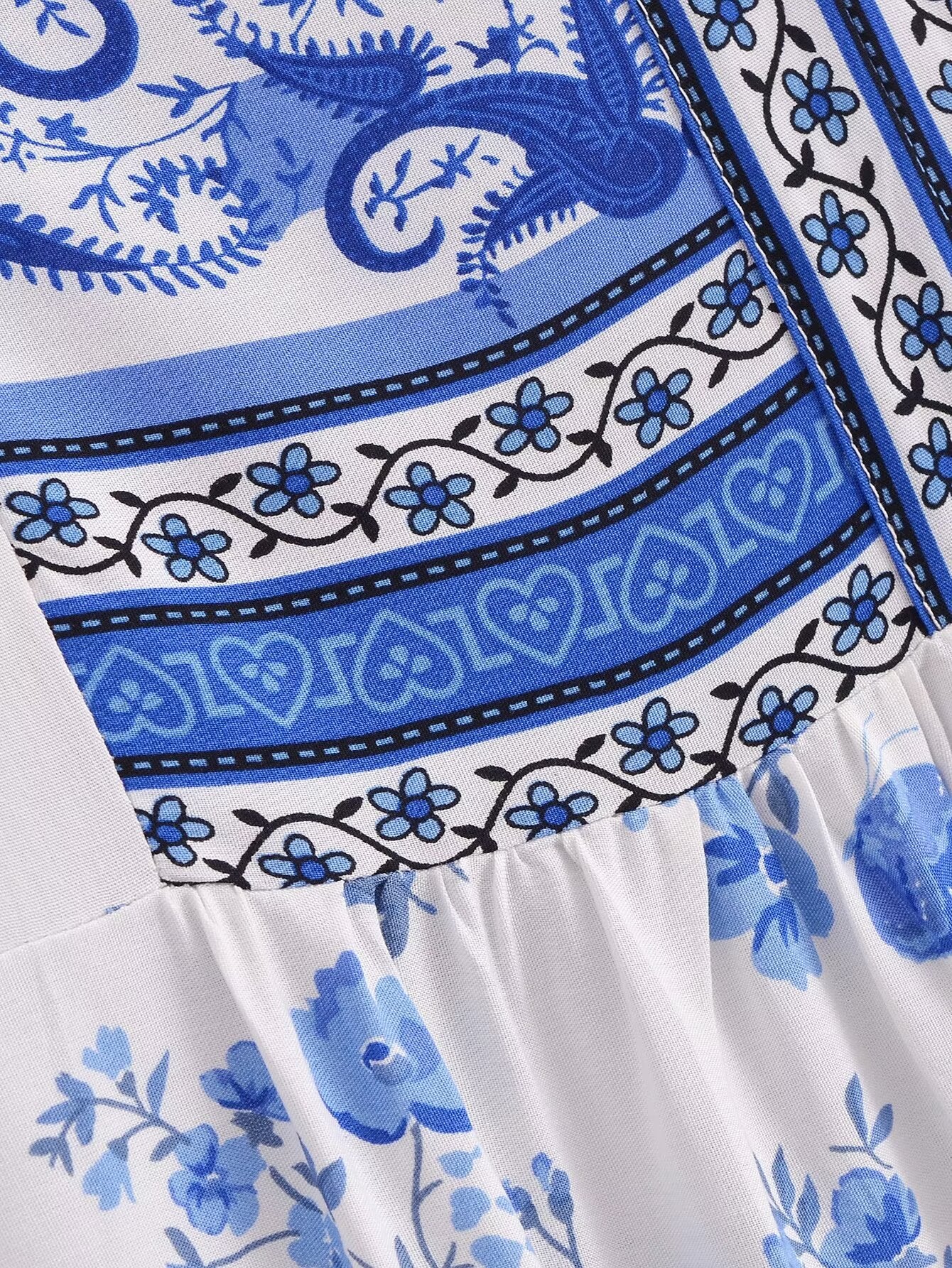 Close-up of blue and white floral pattern on elegant puff sleeve spring midi dress by Malbusaat