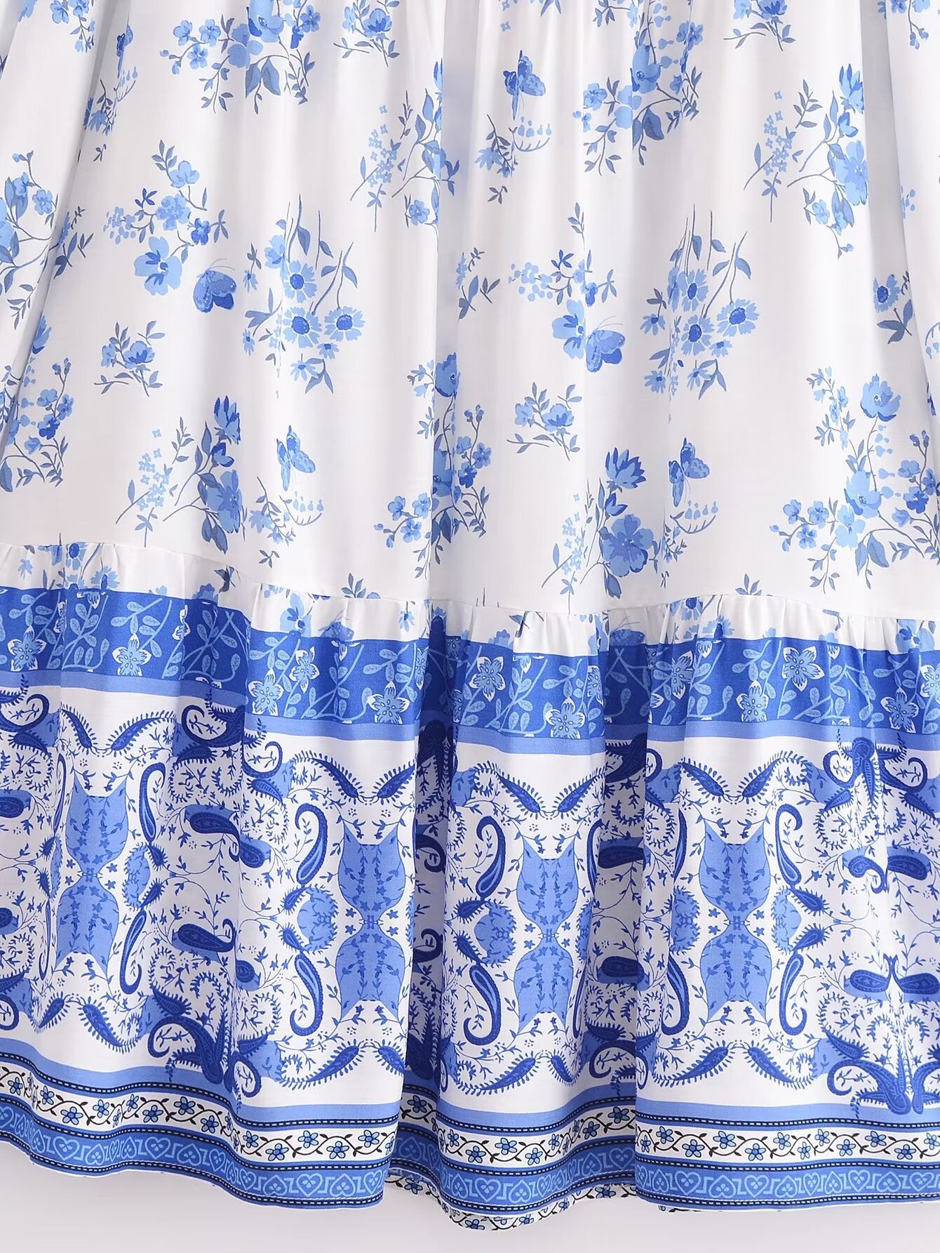 Close-up of Malbusaat elegant puff sleeve spring midi dress with blue floral and ornate patterns