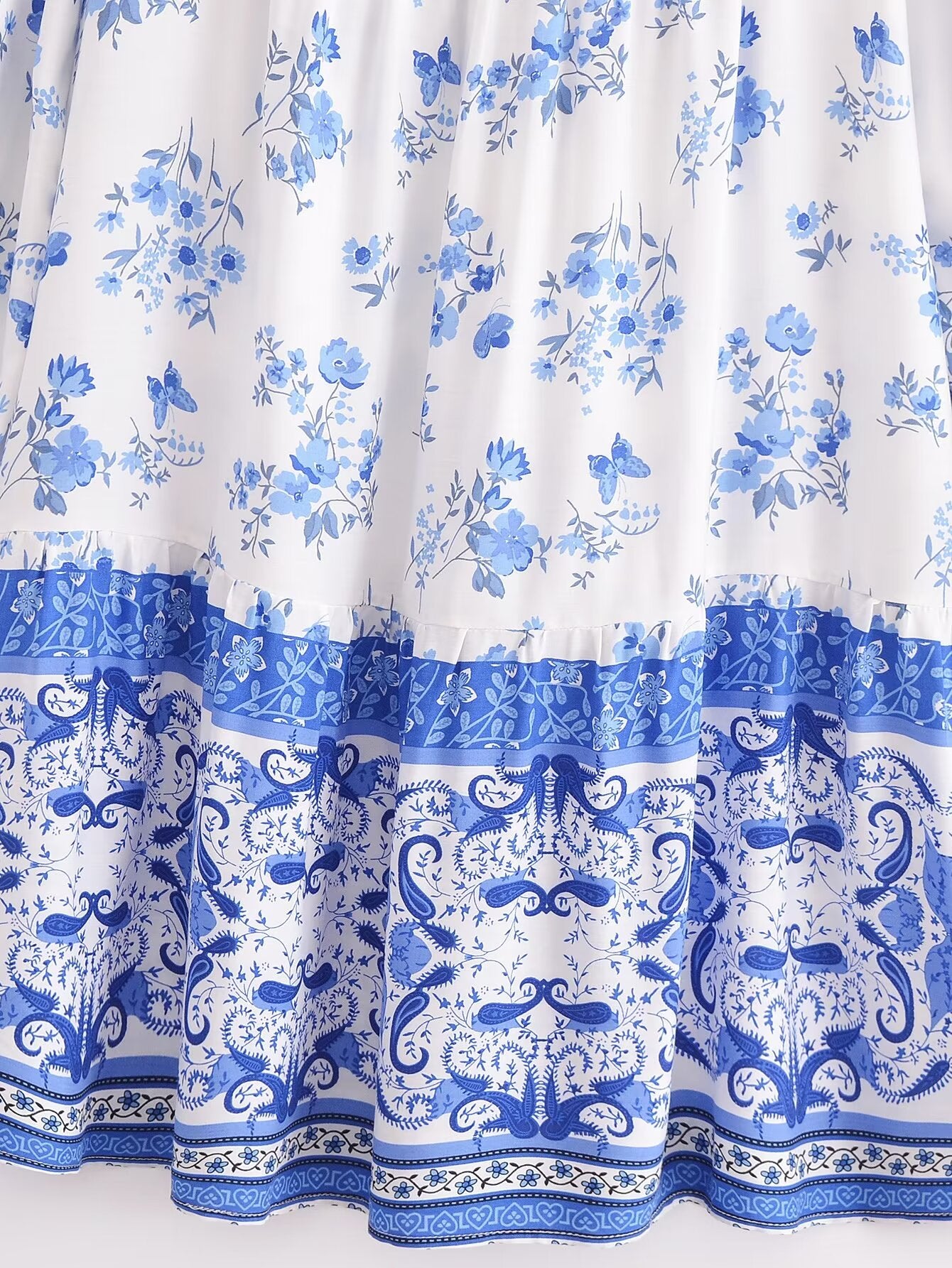 Close-up of Malbusaat elegant puff sleeve spring midi dress with blue floral and paisley print design