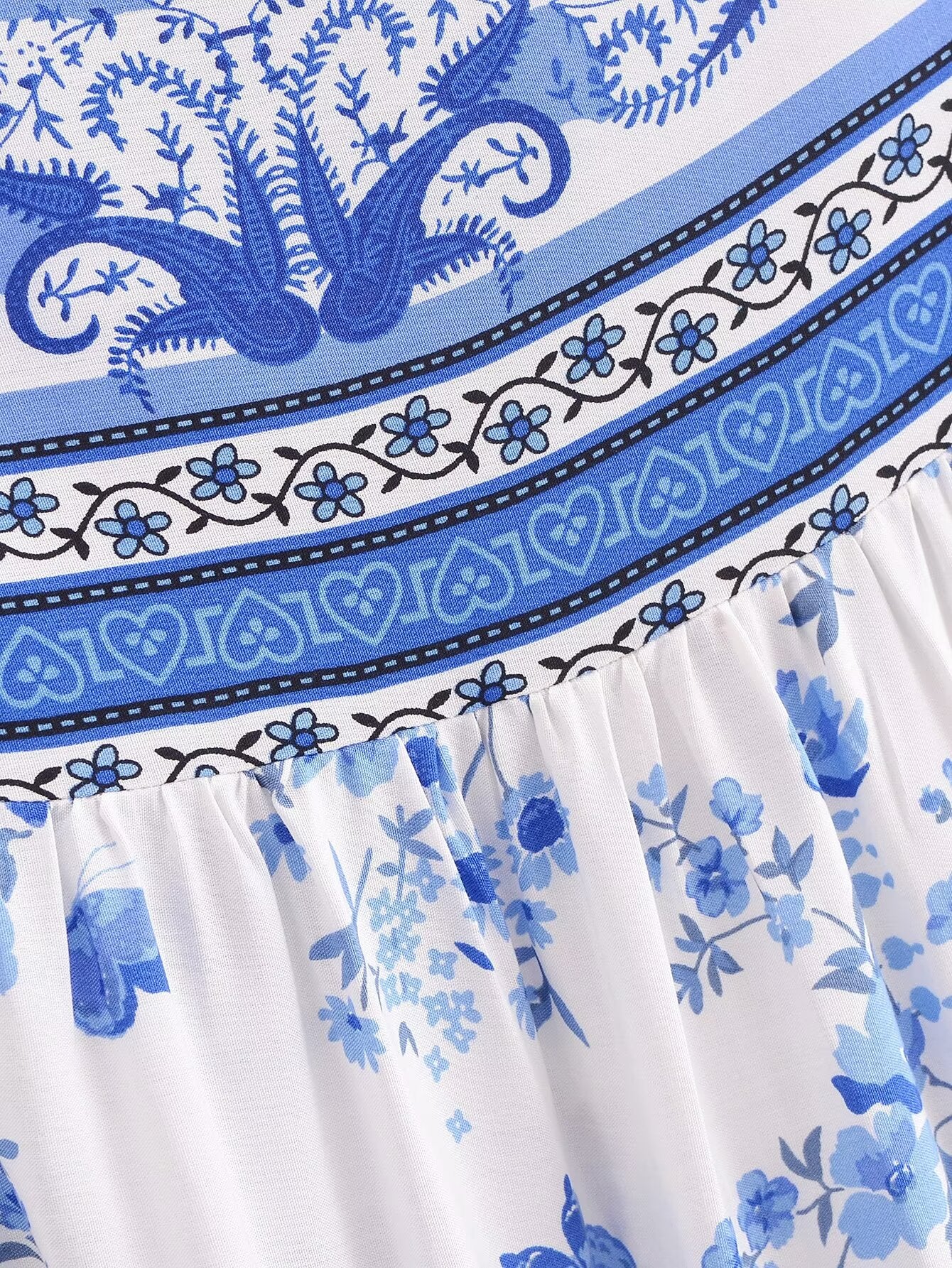Close-up of Malbusaat elegant puff sleeve spring midi dress with blue floral and decorative patterns
