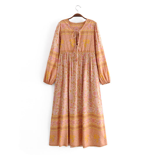 Malbusaat long sleeve rayon tassel dress with floral print and gathered waist in pink and mustard tones