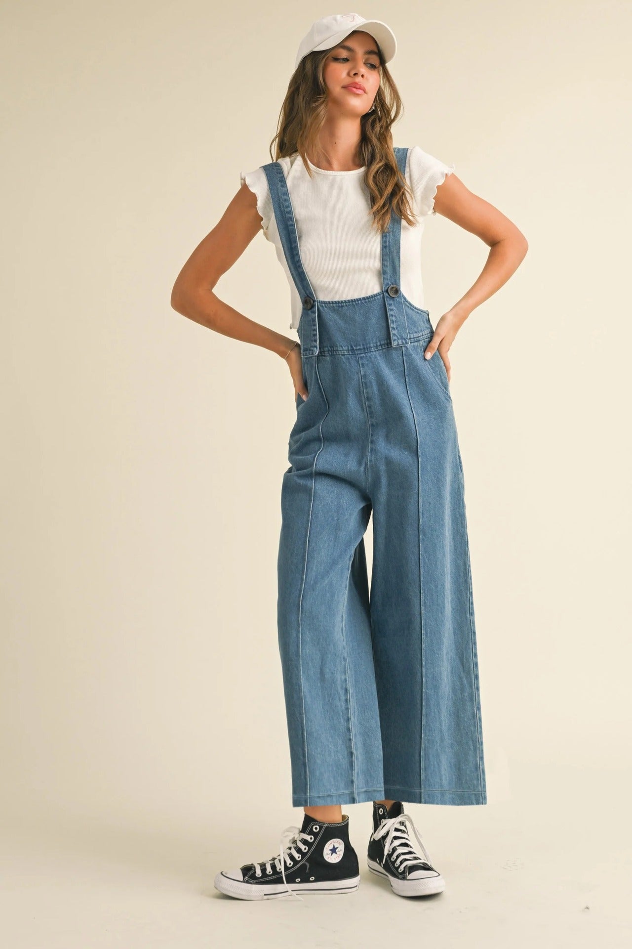 Stylish women's denim suspender pants with wide legs and adjustable straps for a comfortable fit